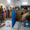 Indian voters casting their vote at a polling booth using EVM and VVPAT during the West Bengal Assembly Election 2026 - পশ্চিমবঙ্গ বিধানসভা নির্বাচন ২০২৬